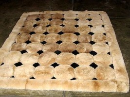 Light brown alpaca fur carpet with black rhombus designs, 150 x 110 cm - $303.80