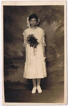 Postcard RPPC Sad Looking Young Lady In White Dress Big Bow &amp; Bouquet - £5.70 GBP