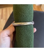 Polished silver bangle with etched design on front - $13.67 CAD