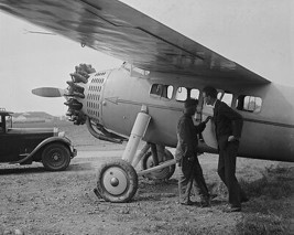 Aviator Charles Lindbergh examines a parked airplane 1929 Photo Print - £7.02 GBP+