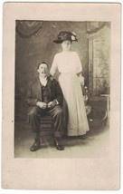 RPPC Real Photo Postcard of Tall Lady in Hat and Husband Sitting 1904-19... - £6.72 GBP