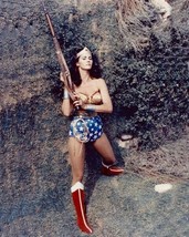 Lynda Carter as TV&#39;s Wonder Woman holding up rifle standing by wall 8x10 photo - £7.64 GBP