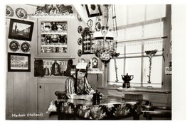 Person sitting at a table inside his cottage in Marken Holland RPPC Postcard - £5.90 GBP