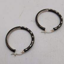 Glossy Black Diamond Cut Hoop Earrings in Sterling SilverCrafted in .925 - $40.00