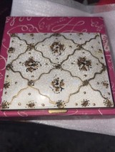 Vintage Schildkraut cloisonne compact with floral display against a whit... - $14.85