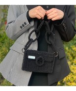 Beaded black bag, with elegant handle  in circles and lining