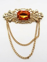 Vtg gold tone orange rhinestone brooch scrollwork background chain details - £11.84 GBP