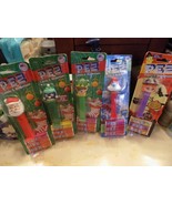 Set of 5 PEZ dispensers, santa, papa smurf, penguin, elf and witch - $284.91 MXN