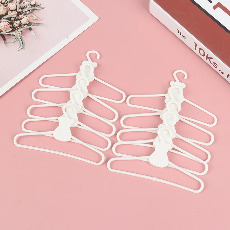 10Pcs/Lot Cute Mini Plastic Hangers Coat Dress Dolls Accessories for Doll - £7.14 GBP+