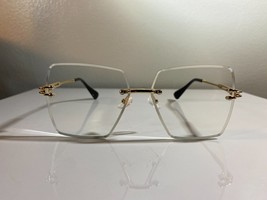 Unisex, rimless, oversized eyeglasses with clear lenses and gold wire fr... - $10.00