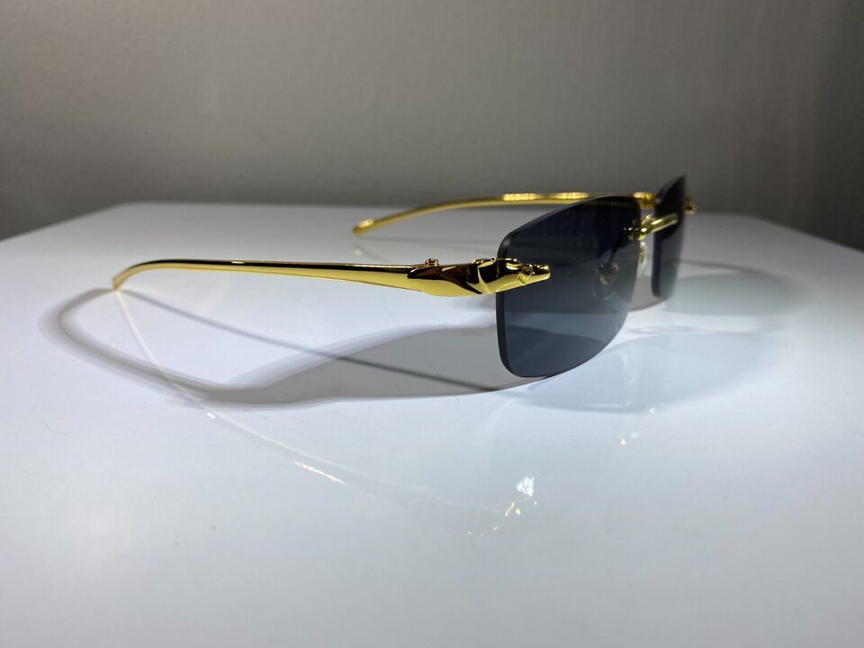 Men&#39;s rimless, rectangular sunglasses with gold wire frame and black lenses - $9.50