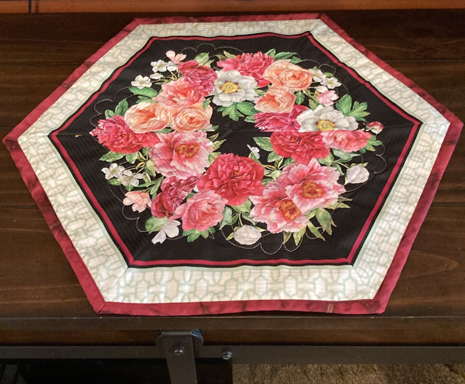 May Blossoming Elegance: A Hexagonal Floral Symphony Table Topper - $25.00