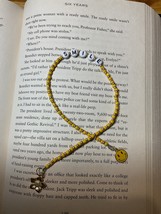 Yellow and gold seed bead bookmark with a smiley face charm and a flower charm. - £4.72 GBP