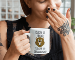 Mockup of a tattooed woman holding an 11 oz coffee mug 27232 thumb155 crop