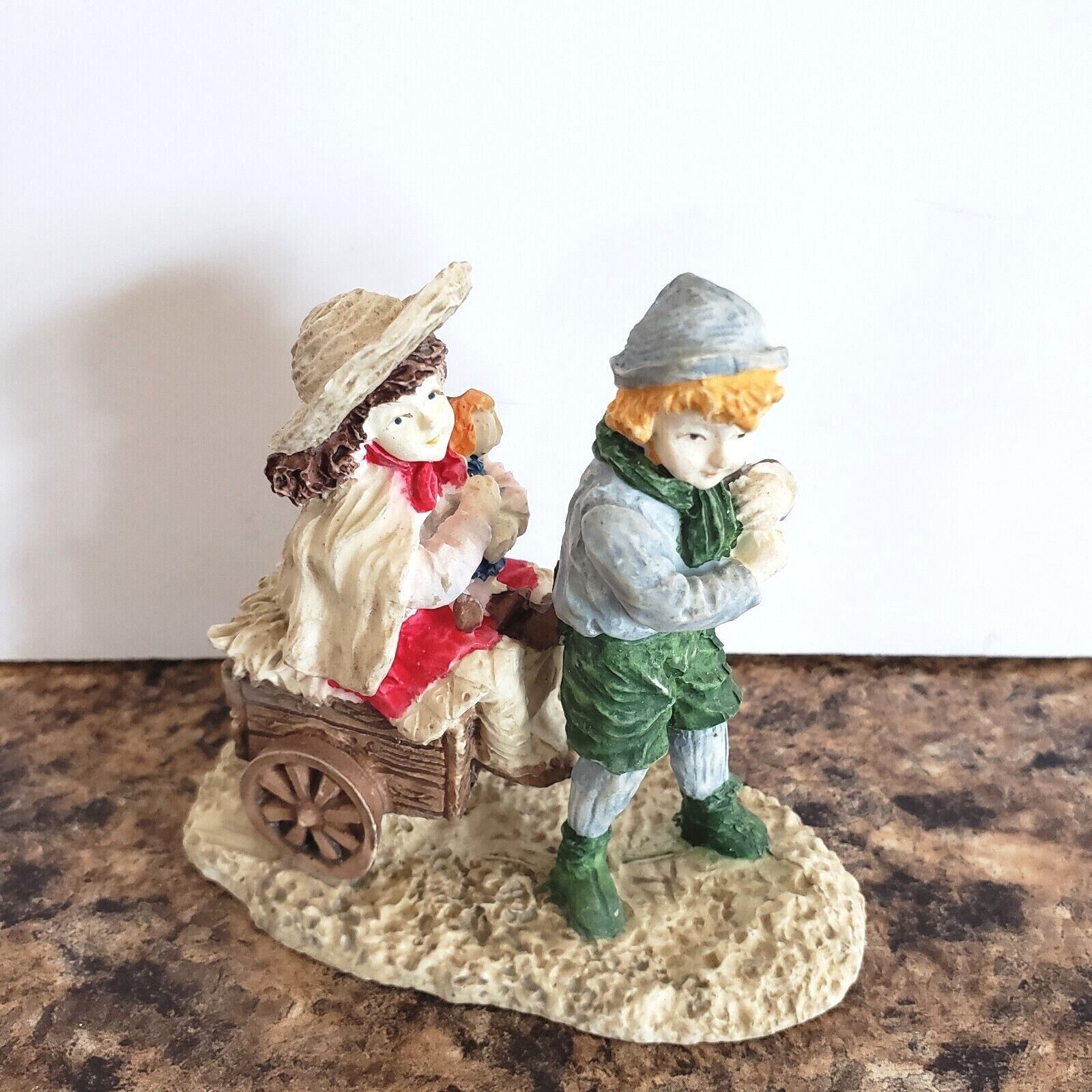 Primary image for Christmas Village Figurine Boy Hauling Girl on a Cart 3"Tall Resin Victorian