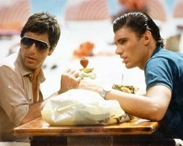 Scarface 1983 Steven Bauer Al Pacino sit having drinks outdoors 24x36 Poster - $29.99