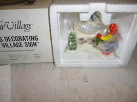 DEPT 56 SNOW VILLAGE 5134-9 &#39;KIDS DECORATING THE VILLAGE SIGN- NEW- L131 - $8.98
