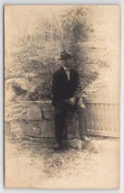 RPPC Dapper Man Sitting On Stone Wall Rustic View Photo Postcard B43 - £10.18 GBP