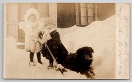 RPPC Girl With Doll Child Shovels Snow With Dog Real Photo Postcard S27 - $19.95