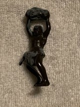 CAVEMAN TYPE FIGURINE wearing a war club at side and holding a rock overhead - $9.95