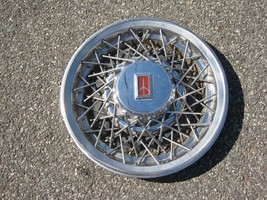 One factory 1982 to 1984 Olds Delta 88 15 inch wire spoke hubcap - $46.40