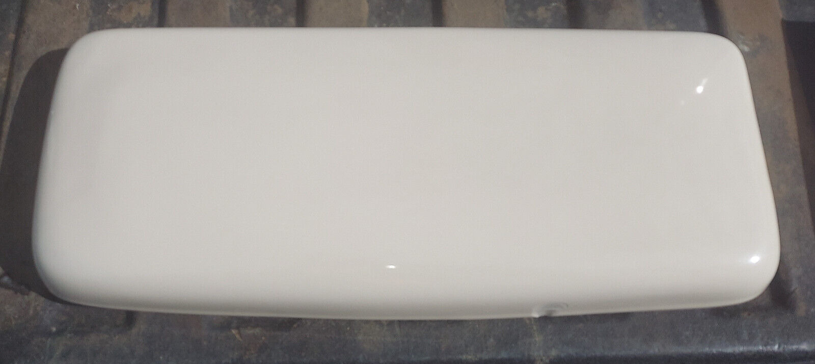 Primary image for 23FF46 TOILET TANK LID, AMERICAN STANDARD 1419RJ, BONE???, CHIP ON FRONT, FAIR