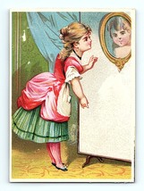 Victorian Trade Card 1880&#39;s Young Lady In Red &amp; Green Dress Stares Into Mirror - £8.70 GBP