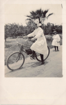Young Girl In White Dress Riding Bicycle On Sandy ROAD~1910s Real Photo Postcard - £9.43 GBP