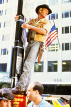 Paul Hogan in Crocodile Dundee climbs New York lamp post 24x18 Poster - $23.99