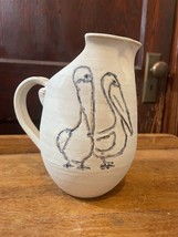 Pottery Pitcher with a Etched Blue Pelicans Signed - $29.02