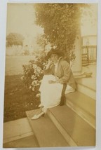 RPPC Woman in A Sweet Seated on steps Near the Flowers Postcard R4 - £5.46 GBP