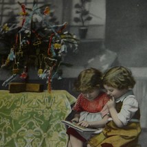 Boy &amp; Girl reading a Book Next to a Christmas Tree Antique Christmas Postcard - £8.40 GBP