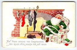 Santa Claus Christmas Postcard Green Suit Chair Black Cat Sleeps By Fireplace - £10.46 GBP