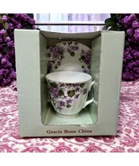 NIB Gracie Bone China Tea Cup And Saucer Purple Violets flowers greenery... - $569.73 MXN