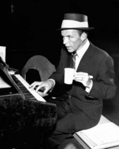 Frank Sinatra in suit and hat sits at piano holding cup of coffee 8x10 photo - $9.75