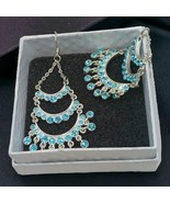 Silvertone dangle earrings - $278.46 MXN