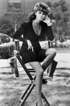 Raquel Welch in short black dress sitting on studio chair 18x24 poster - £23.58 GBP
