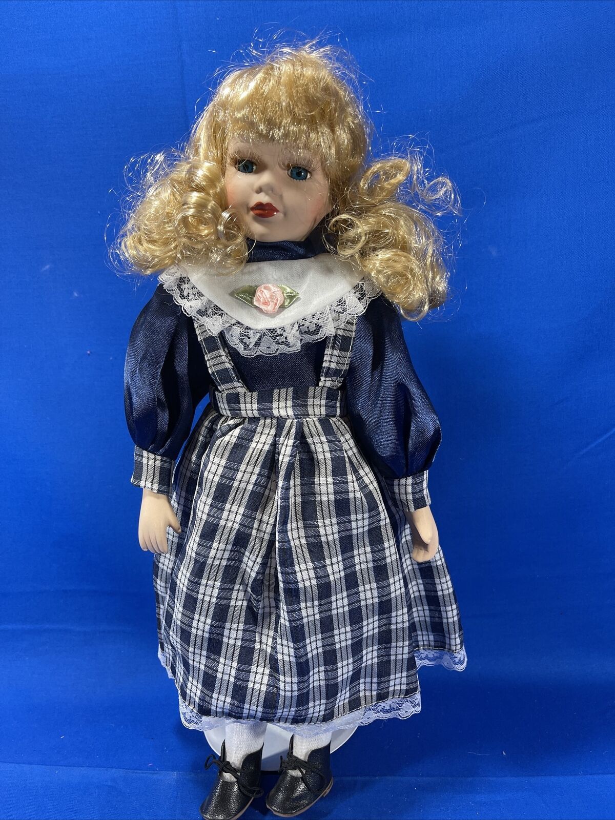 Porcelain doll with blonde hair and blue eyes deals