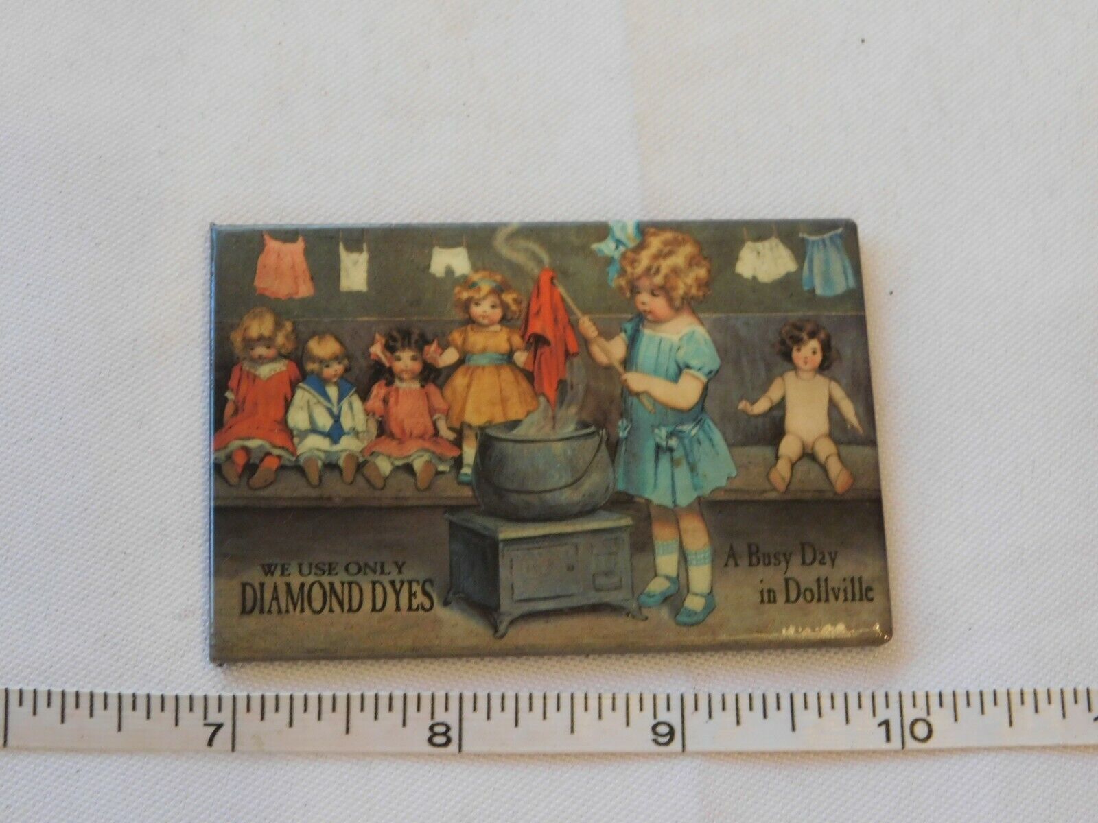 Primary image for Desperate Enterprises A Busy Day in Dollville magnet 2 1/8" X 3" Pre-owned