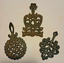 3 CAST IRON TRIVETS ONE IS A WILTON - $18.50