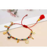Red thread protection bracelet with Turkish evil eye and various charms.... - $16.00