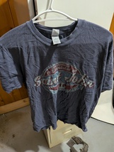 greyish-blue vintage-style t-shirt featuring a "Saint John" graphic for ... - $1.00