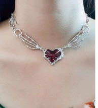 Skeleton hand red heart choker necklace - $269.55 MXN