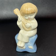 Porcelain Figurine Child Sitting on Star Playing Guitar Vintage - $221.44 MXN