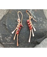 Handmade copper earrings: abstract wire wrapped wings with faceted red b... - $541.02 MXN