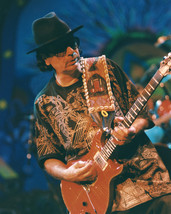 Carlos Santana iconic pose in black t-shirt on stage performing 8x10 Photo - $7.99