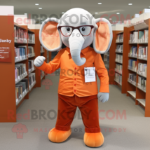 Orange Elephant mascot costume character dressed with a Dress Pants and Reading  - $1,299.00