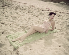 Ann Miller light pink swimsuit on sand sunbathing 16x20 Poster - $19.99