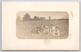 RPPC Ladies And Men Posing In Field of Flowers Photo Postcard V22 - £7.84 GBP