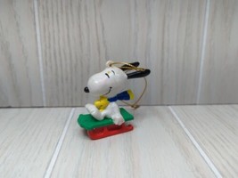 Whitmans Snoopy on Sled wearing scarf Christmas Tree Ornament - $5.93